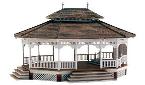 Woodland Scenics Grand Gazebo - HO Scale Item # BR5035. The Grand Gazebo offers a panoramic view in any layout's village or city park. It is the perfect gathering place for social events like spring weddings, summer family reunions, Sunday afternoon jazz sessions, and it can even be a shady getaway for picnics! The Grand Gazebo includes realistic weathering, an open floor plan and one LED light. See photos for footprint.
This structure comes with pre-installed LED lighting made for use with the Just Plug® Lighting System. 25mA
RoHS Compliant
Colors may vary from actual product.