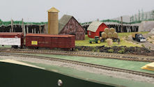 A busy rail yard featuring multiple freight cars, locomotives, and cargo containers.