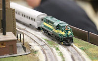 A bustling railway yard with locomotives being serviced at a maintenance depot.