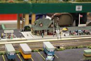 Train station scene at night with overhead lights.