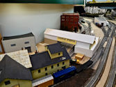 A detailed railway crossing scene with signal lights and train barriers.
